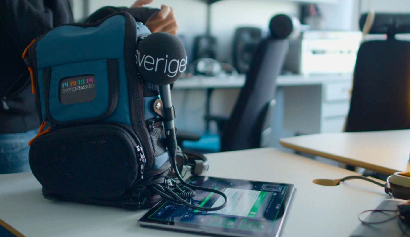 Sveriges Radio field kit — branded backpack, mic and a tablet running the touch interface